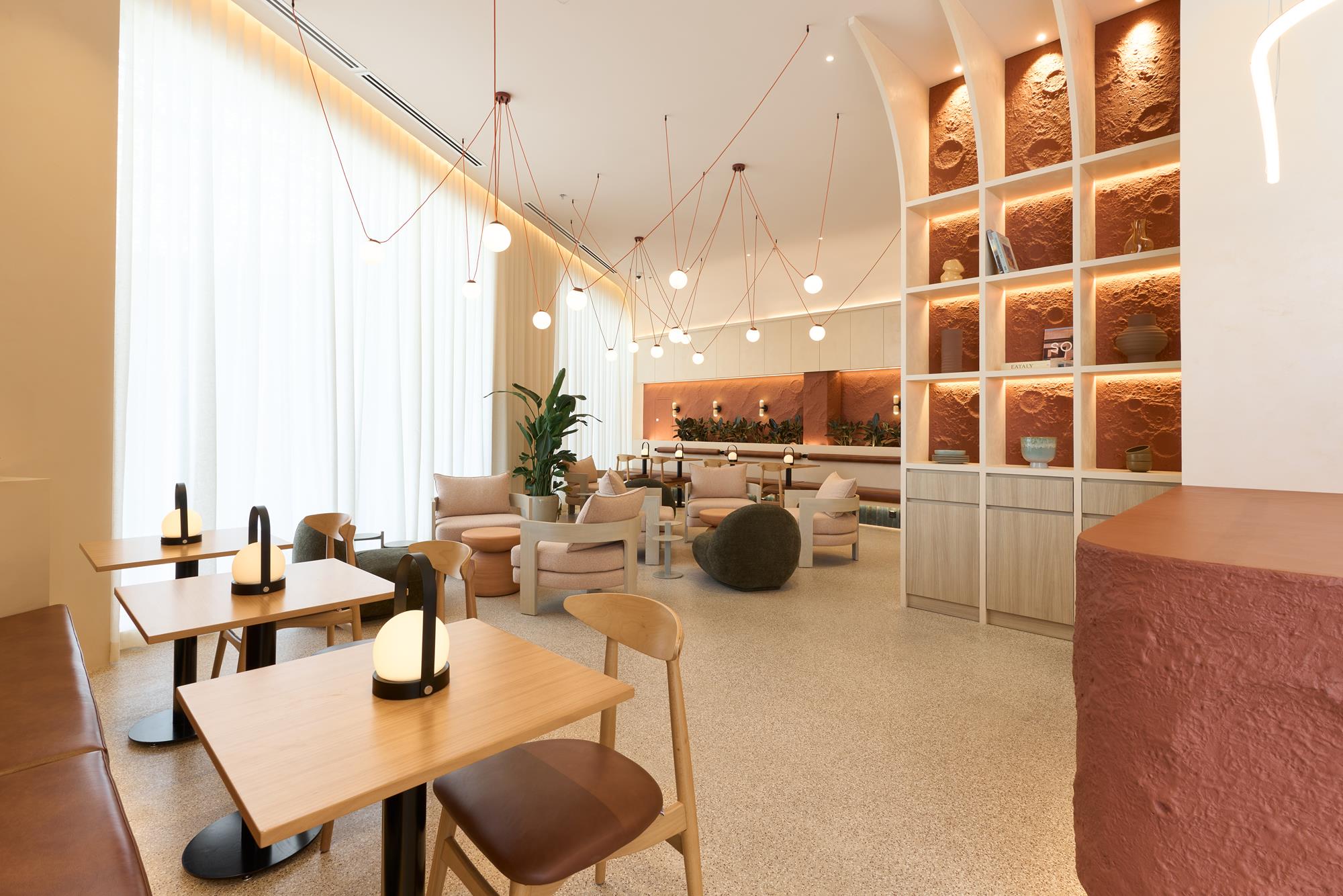 A warm hospitality lounge with terracotta walls and soft furnishings