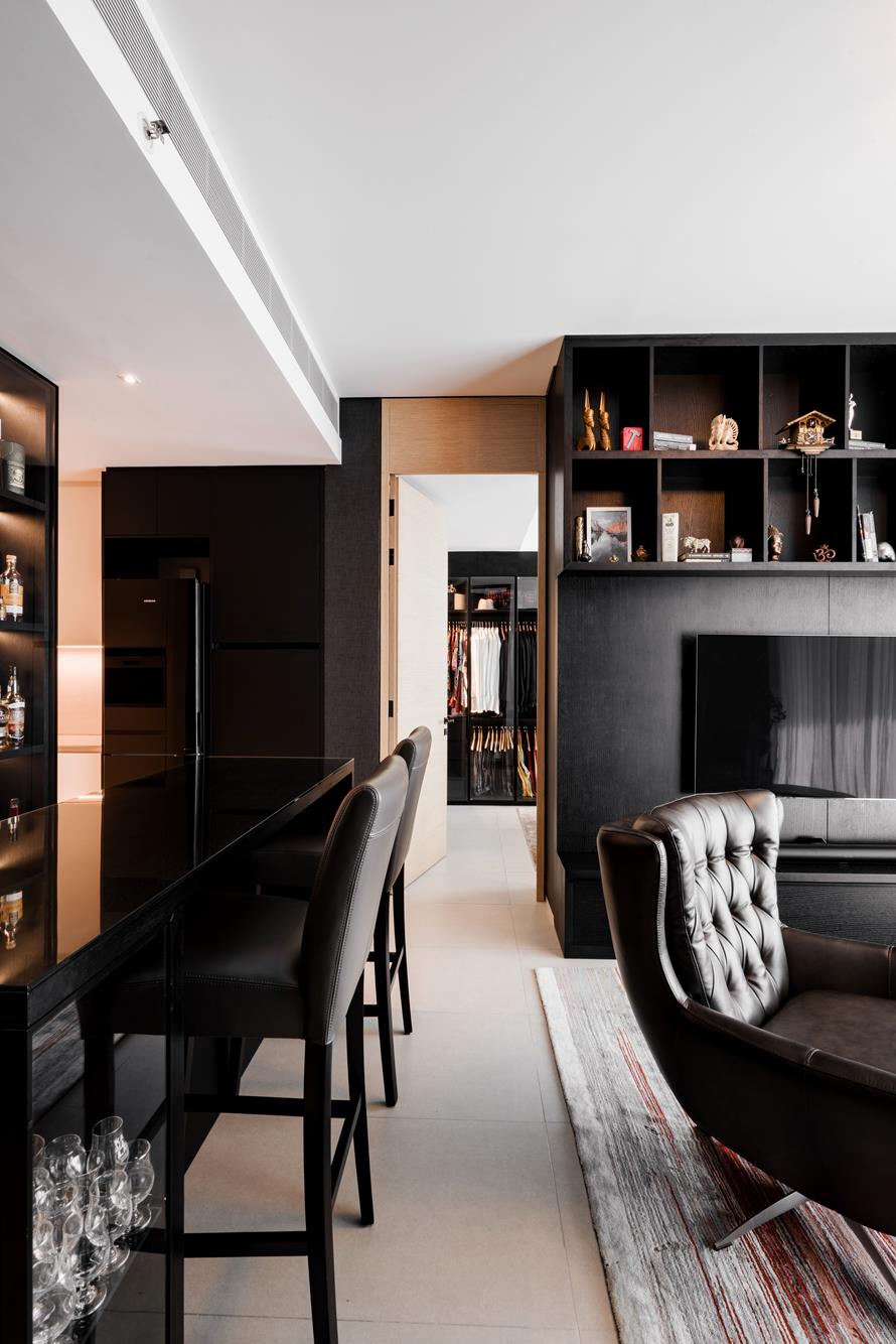 A black bar counter running toward the dressing room, cabinets glowing on either side