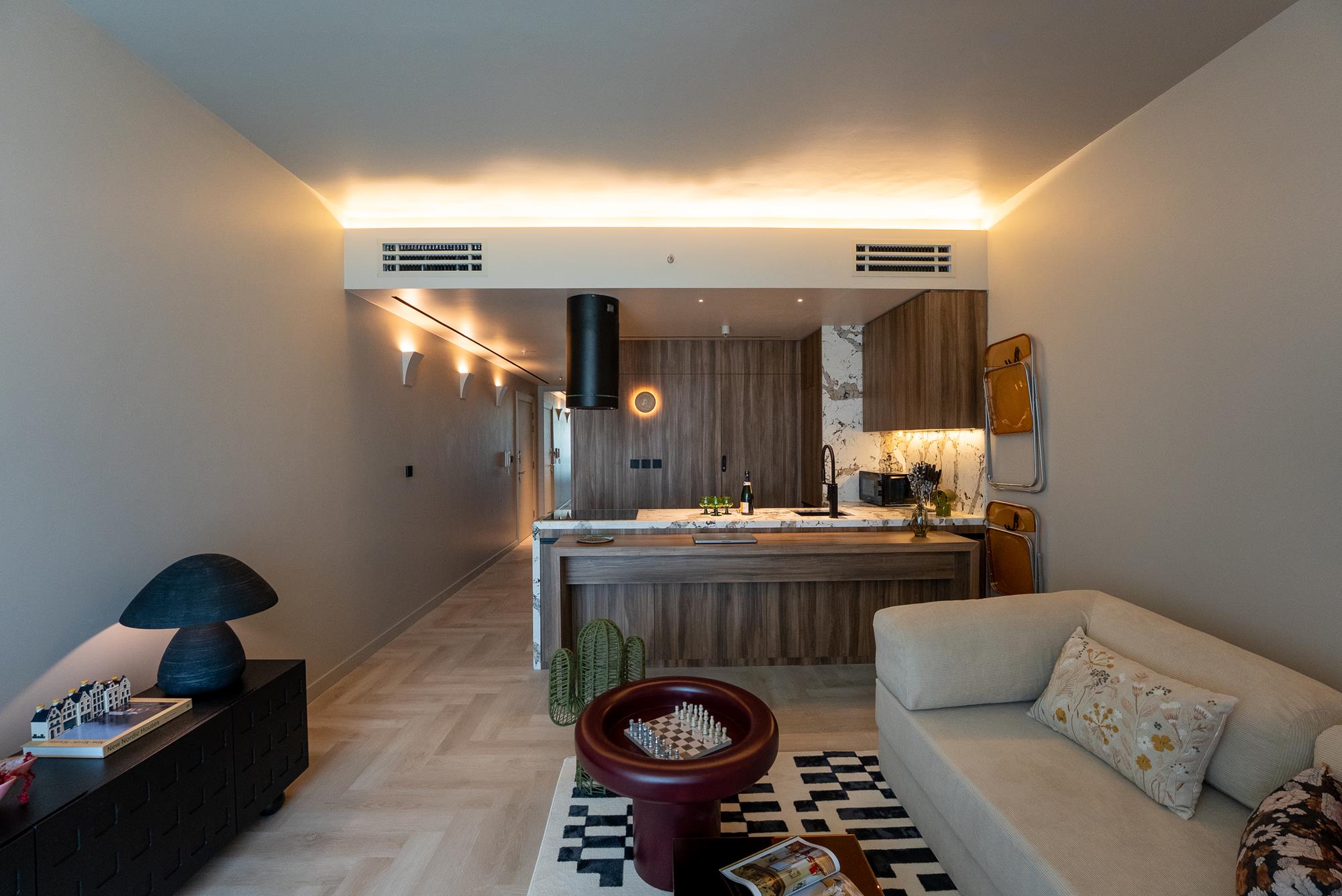 A daylit living space with layered, multifunctional furniture