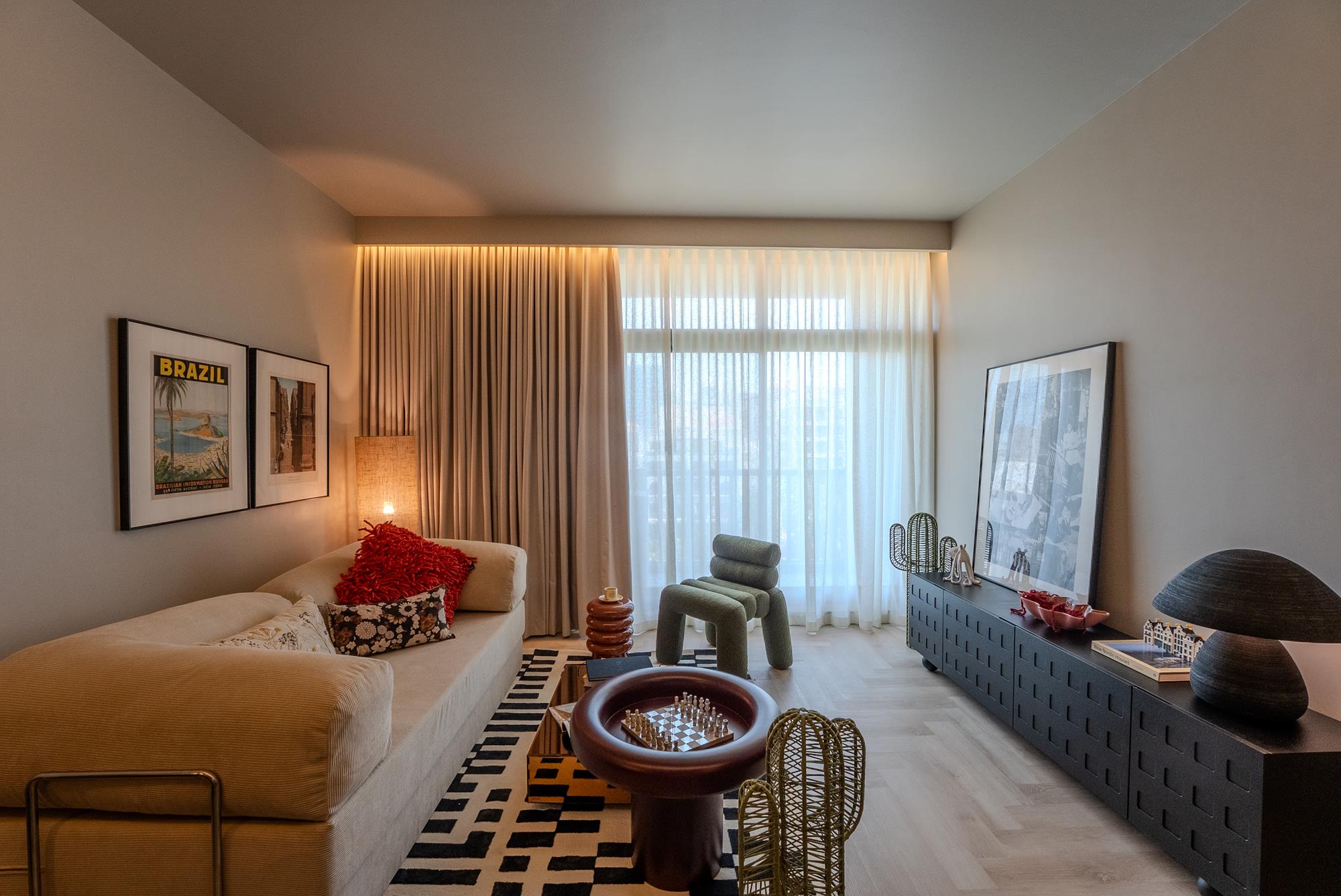 A living area with corduroy sofa and moss bouclé chair